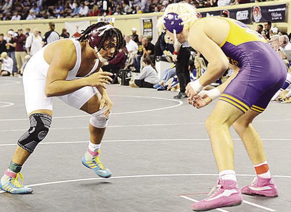 Malachi Lorne, left, stares down his opponent during the firstplace match of the 190-pound weight class in the 4A State Wrestling Tournament at the Jim Norick Arena over the weekend. CDN | Sam Goodwyn