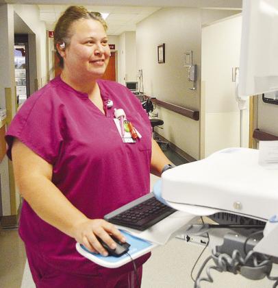 Lauren Coppock fills out a patient report in the emergency room entryway at Clinton Regional Hospital. CDN | Micah Ashcraft