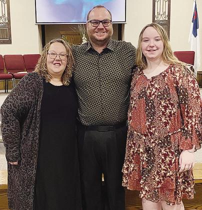 Jamie Patton, center, smiles with his wife Kelli, left, and daughter Carli after being selected as the new pastor at New Hope Fellowship Church. CDN | Courtesy photo