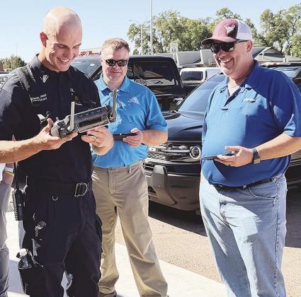 Lt. Tyler Calvert shows off the capabilities of the Clinton Fire Department’s drone to Tim Miller and Billy Goodwin at a recent Noon Lions meeting. CDN | Shiann Dawson