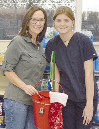 Anne Lambeth and Rachel Red greet shoppers at United while ringing the bell to raise money for the Clinton Mission House this Christmas.