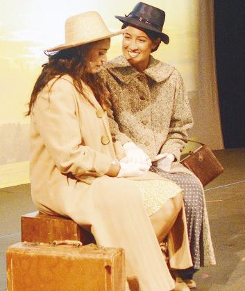 Blair Barnett Green, left, and Angela Nichols share a train ride together to start the second act of the Southwest Playhouse’s production of “Bright Star.”