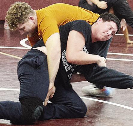 Clinton’s Marcus Wilson, top, grapples with Layne Spitz during wrestling practice last week. CDN |Sam Goodwyn