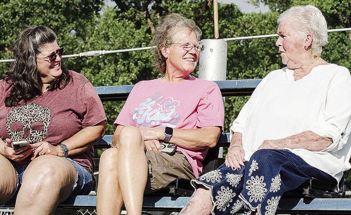 From left, LaDonna Lucas, JaNelle Randy, and Carolyn Roulet talk prior to the start of the Clinton Round-Up Club Rodeo at the Round-Up Club Arena. CDN | Sam Goodwyn