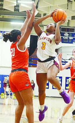 No. 3 Arelena Kirkendoll drives into a Cushing defender, as she attempts to lay up the ball during Clinton’s road playoff game against the Lady Tigers Thursday in Kingfisher. CDN | Sam Goodwyn