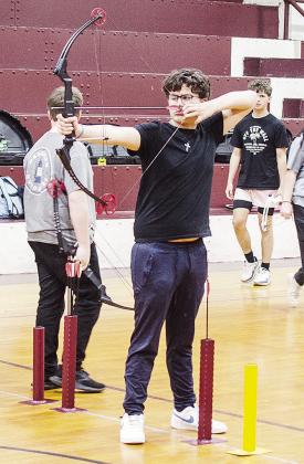 Clinton’s Jaeden Tortoledo aims his bow as he prepares to fire during archery practice Wednesday at the old Clinton Middle School Gym. CDN | Sam Goodwyn