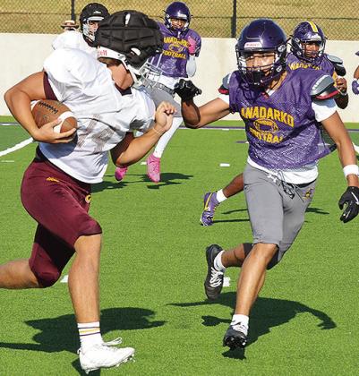 Clinton’s Vince Jones, left, hustles downfield as he prepares to fight off a defender during the Red Tornadoes’ scrimmage in Anadarko. CDN | Sam Goodwyn