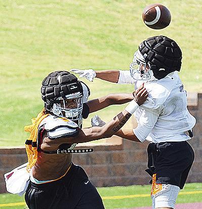 DJ Lister, left, battles with Jason Lloyd for the ball during practice. CDN | Sam Goodwyn