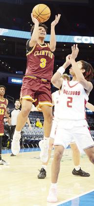Clinton’s Titan Malone shoots a jump shot against a Cache defender during the Reds’ game Wednesday against the Bulldogs in the Paycom Center. CDN | Sam Goodwyn