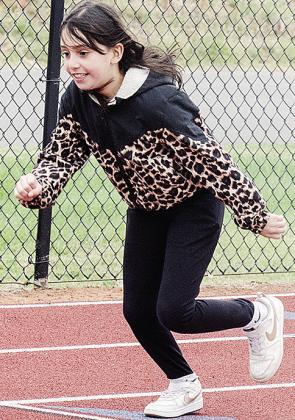 Leah Guzman sprints to kickoff a race during the Little Olympics event at the high school. CDN |Sam Goodwyn