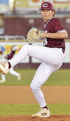 Clinton’s Ben Daughtery winds up to pitch during the Reds’ second game against Leedey Thursday night. CDN | Sam Goodwyn