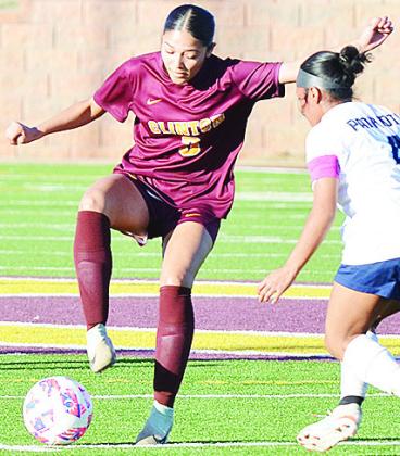 Clinton’s Alyson Lopez changes direction to avoid the Putnam City West defender during the Lady Reds’ home win over the Lady Patriots. CDN | Sam Goodwyn