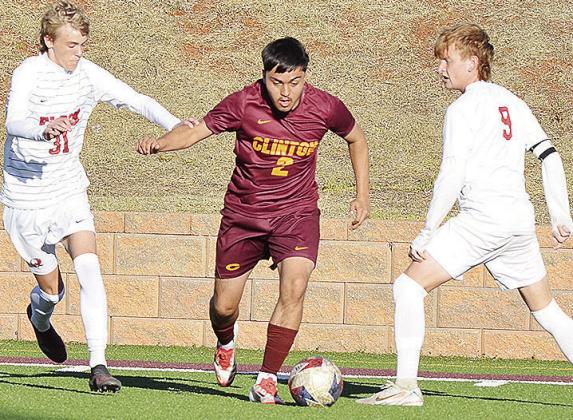 Clinton’s Alex Guzman splits two Elgin defenders during the Red Tornadoes’ win over the Owls in the Tornado Bowl. CDN | Sam Goodwyn