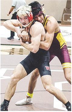 Vicente Gutierrez, right, grapples with his opponent Tuesday during the District Duals. CDN | Sam Goodwyn