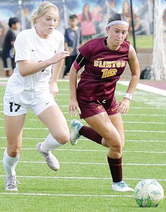 Clinton’s Lady Reds senior Emma McCommas races the Heritage Hall defender to the ball during Clinton’s regular-season ending game against the Lady Chargers in the Tornado Bowl. CDN | Sam Goodwyn