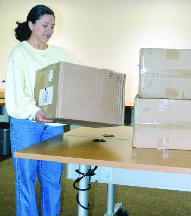 Colombia Castro prepares the supplies for the Box Fan Drive slated tomorrow at Sinor EMS. CDN | Christian Jacobsen
