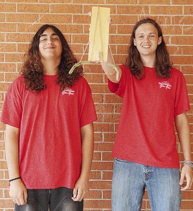 Clinton High School seniors Maliki Jones, left, and Jackson McCullough show off their second-place winning project in the Helping Hands competition against other schools while at the University of Oklahoma’s Gallogly College of Engineering’s Open Hous