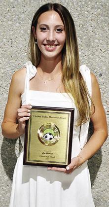 Clinton’s Zoe Howell is all smiles as she proudly holds up her Lindsey Rubio Memorial Award after the annual soccer banquet Sunday at the Frisco Center. CDN | Sam Goodwyn
