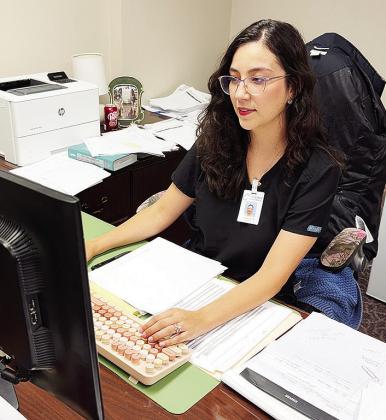 Stefanie Bustos works on checking financials for Clinton Regional Hospital. CDN | Shiann Dawson