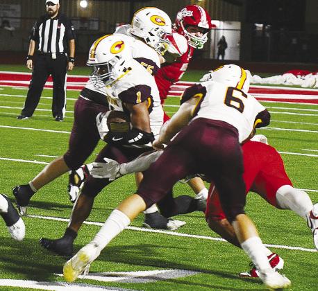 Clinton’s No. 6 Benton Bridgeman and No. 55 Bryson Snider provide key blocks for No. 1 Derren Hester as he carries the ball up the field during the Red Tornadoes’ road game Thursday against Cache. CDN | Micah Ashcraft