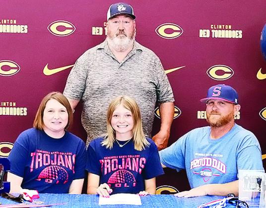 Clinton’s Rylee Cummins, center, is all smiles after signing to play college golf for Seminole State. Pictured with her, from left, is her mom Ashley Cummins, left, her dad Wade Cummins, right, and Seminole State Golf Coach Ronnie Williamson. CDN | Cour