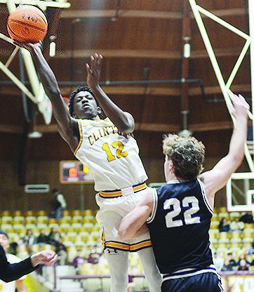 Clinton’s Atticus Thompson flies through the air for the layup during the Reds’ game against Bethany last year in the Tornado Dome. CDN | Sam Goodwyn