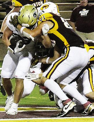 No. 81 Ben Daugherty takes down the Heritage Hall player during Clinton’s home opener Friday against the Chargers in the Tornado Bowl. CDN | John Kinsey