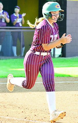 Clinton’s Laney Anderson claps as she runs to first after hitting the ball into the outfield for a hit against Bishop McGuiness at home Tuesday. CDN | Sam Goodwyn