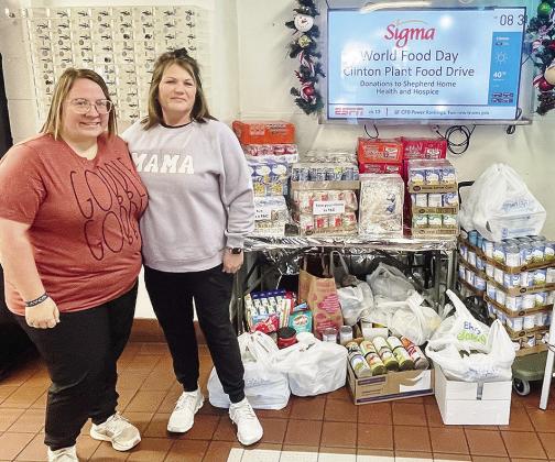 Kelli Miller-Oliver, left, and Darlene Cardwell with Shepherd Home Health &amp; Hospice stand in front of the many food items donated by the Bar-S Foods Clinton Plant in recognition of World Food Day. CDN | Courtesy photo