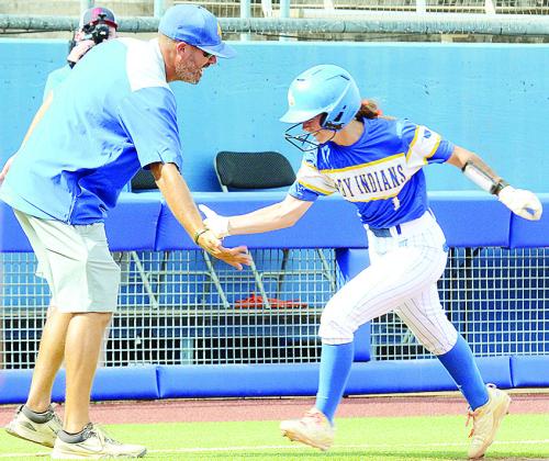 Arapaho-Butler’s Kylin Oakes, right, high fives Coach Luke Thompson as she rounds third during her home run trot which started the scoring for the Lady Indians against Caddo in the Class A State Championship game Saturday at Devon Park in Oklahoma City.
