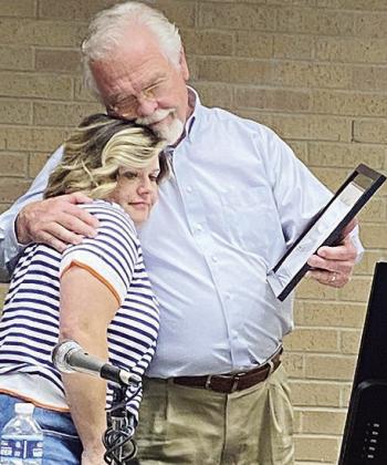 Stormie Bowen, left, gets a hug from Mayor David Berrong after her final council meeting. CDN | Staff Photo