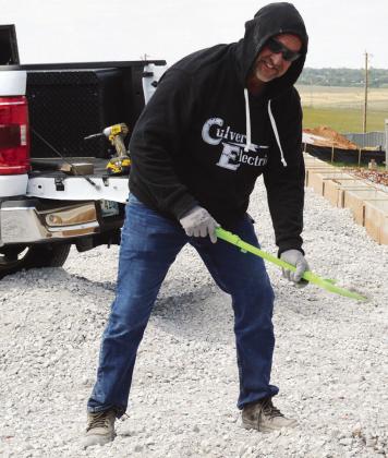 Subcontractor Jeremy Fisher spreads out rock and gravel using Bryler Daggs’ shovel recently at the Clinton Regional Airport. Daggs, his grandson, placed the shovel into his work truck and told him, “I’ll let you use my shovel at work.” CDN | Christian Jacobsen