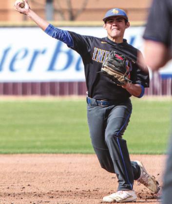 Eric Flores makes a throw to first base