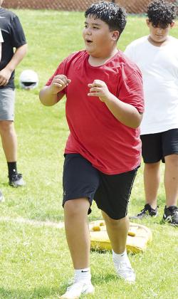 CDN |Sam Goodwyn Edwin Mejia performs an imaginary block in a lineman drill during practice last week at the middle school.
