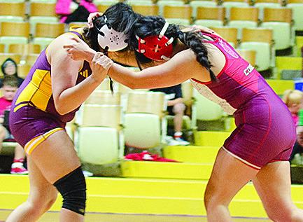 Lady Reds Kassandra Kaline, left, grapples with her opponent during Clinton’s exhibition match with Hinton’s girls’ wrestling team Thursday. CDN | Sam Goodwyn
