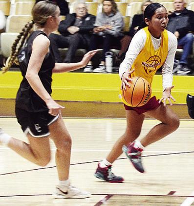AJ Spottedwolf dribbles the ball away from the Elkette defender during the Clinton girls’ JV home basketball game against Elk City. CDN | Sam Goodwyn