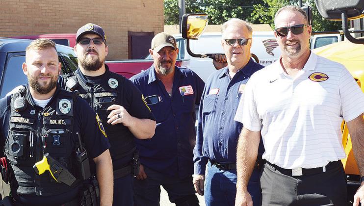 From left, Clinton Police Department School Resource Officers Andrew Wilson and Dillon Whitten, Nate Burnett, Rick Challis, and Transportation Director Jeff King get ready to roll out after a meeting at the Clinton Public Schools Bus Barn. CDN | Micah Ash