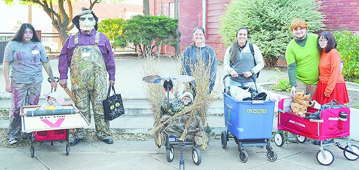 In the “Under 1” age group, from left, Ivan Gallegos, son of James Gallegos and Kara Bearshield, won first place as a mouse in a mouse trap. Weston Powell, son of Tucker and Chaley Powell, won second as a duck hunter. Brice Hunter as a raccoon, son of
