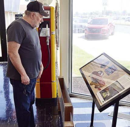 Dave Ketchum from St. Louis, Mo., examines the Corvette display Wednesday at the front of the Oklahoma Route 66 Museum. CDN | Sam Goodwyn