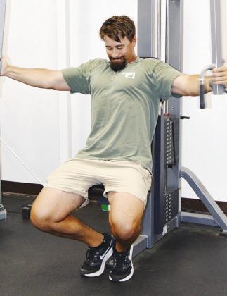 Brooks Red isolates his chest with a “butterfly” machine workout at the Acme Brick Park weight room. CDN | Christian Jacobsen