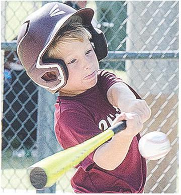 Clinton’s Timmy Sorter puts all of his strength behind his swing during the Reds’ first-round game of the OK Kids 8U Baseball State Tournament Thursday at Schumacher Fields at Acme Brick Park. CDN | Sam Goodwyn