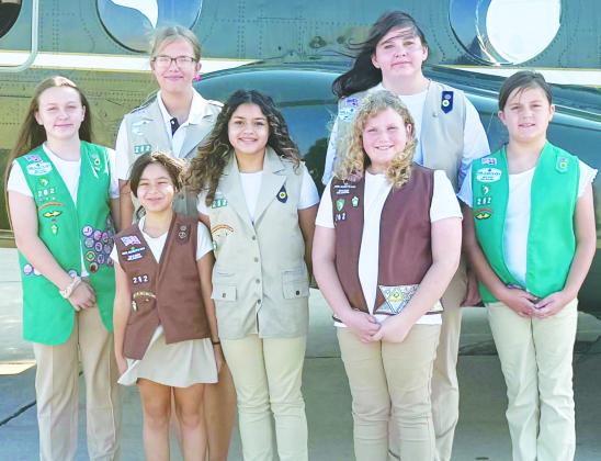 Troop 262 Girl Scouts, front left, Paislee Hawthorne, Camila Murphy, Melanie Moy, Lily Martinez, Preslie Hines; back, Kendra Jones and Emorie Hines stand next to a U.S. Marine helicopter.