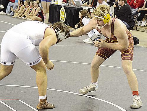 Clinton’s Marcus Wilson, right, sizes up his opponent from Wagoner during the 215-pound weight class first-place match of the Class 4A State Wrestling Tournament. CDN | Sam Goodwyn