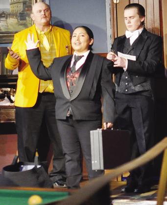 Mr. Boddy (Diana Torres) talks about blackmailing the guests during Southwest Playhouse’s production of “Clue.” In disbelief are Colonel Mustard (John Williams), left, and Wadsworth (Whitten Eustace). CDN | Staff Photo