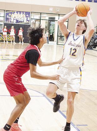 No. 12 Brady Kauk shoots the ball over a Hinton player during A-B’s home game against the Comets. CDN | Sam Goodwyn