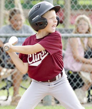 Lincoln Blundell focuses on the ball as he prepares to swing during Clinton’s game in the OK Kids 8U State Baseball Tournament at Schumacher Fields at Acme Brick Park. CDN | Sam Goodwyn