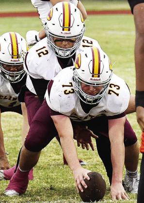 No. 73 Joel Badillo prepares to snap the ball to his quarterback No. 12 Sutton Hernandez in Oklahoma City during Clinton’s final regular season game against Douglass. CDN | John Kinsey