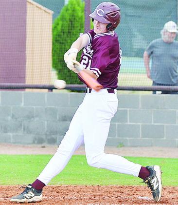 Clinton’s Ayden Crumley swings at the ball during the Reds’ home game Monday against Woodward. CDN | Sam Goodwyn