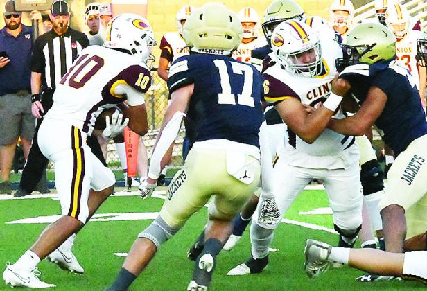 Clinton’s No. 10 JJ Ruiz carries the ball while Andre Lime, right, provides a block for him during the Red Tornadoes’ road game Friday against Kingfisher. CDN | John Kinsey