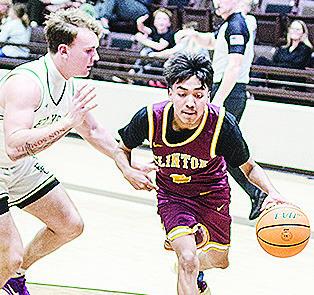 Clinton’s Ronnie Redshin, right, drives around an Elk City defender. CDN | Sam Goodwyn